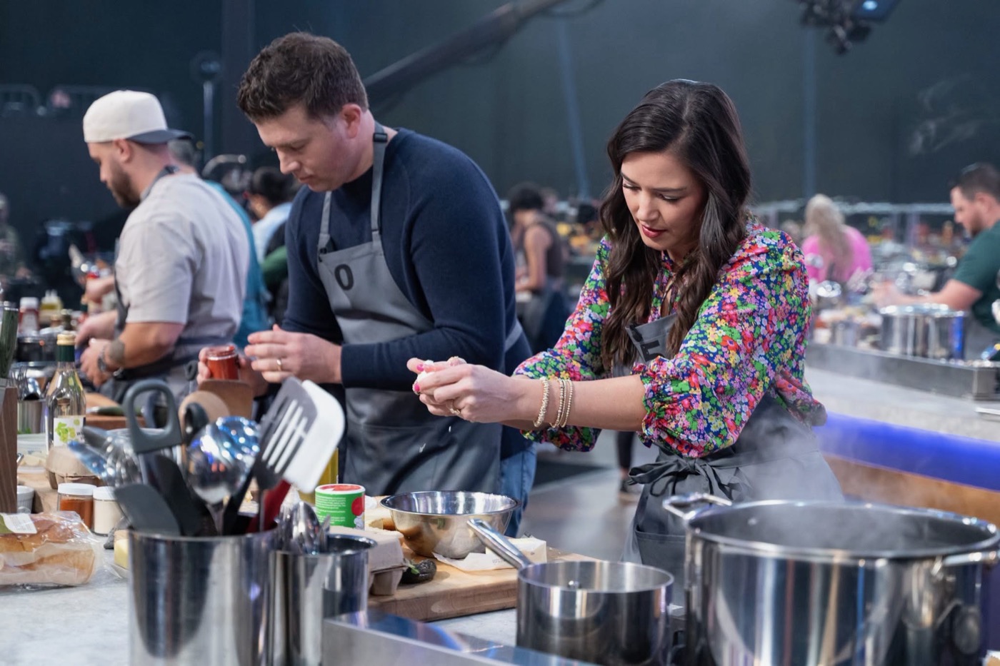 Holley plating a dish on the 100 Cooks set